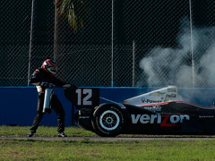 Will Power takes action to put out the fire in his car