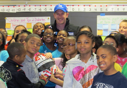 Charlie Kimball with classroom children