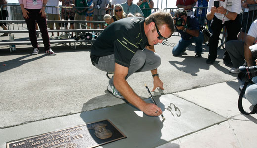 Ed Carpenter signs his name at Auto Club Speedway