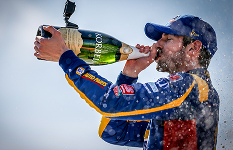 Alexander Rossi drinks champagne