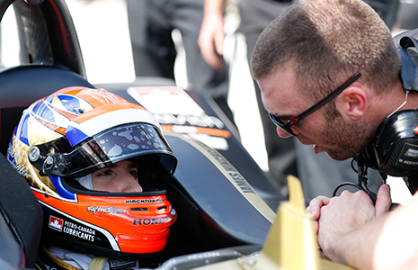 James Hinchcliffe in car talking with crewman