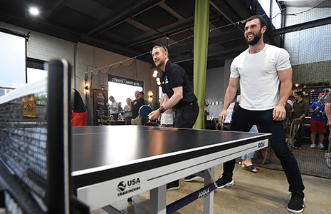 Charlie Kimball and Andrew Luck playing ping pong