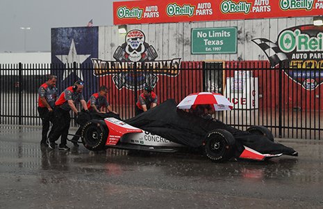 Marco Andretti car covered by tarp in rain at Texas