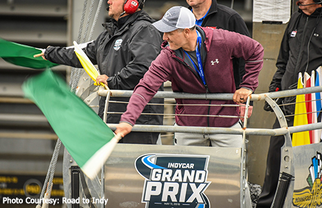 Adam Vinatieri waves green flag at USF2000 race