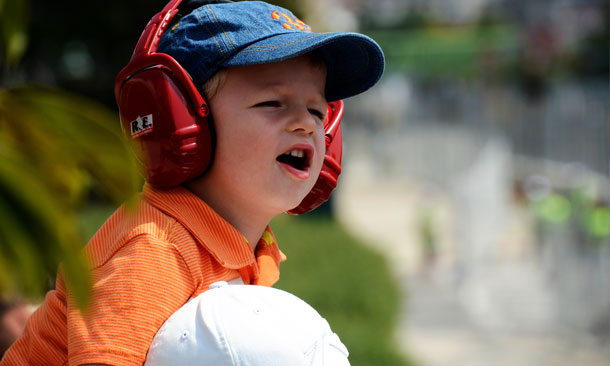A young fan watches the track action