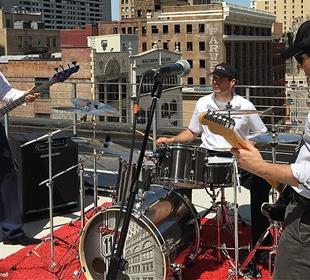 Power shows off rooftop drum skills to rock classics