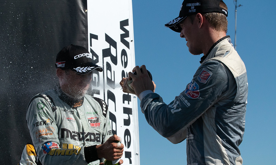 Oliver Askew sprays champagne on Rinus VeeKay
